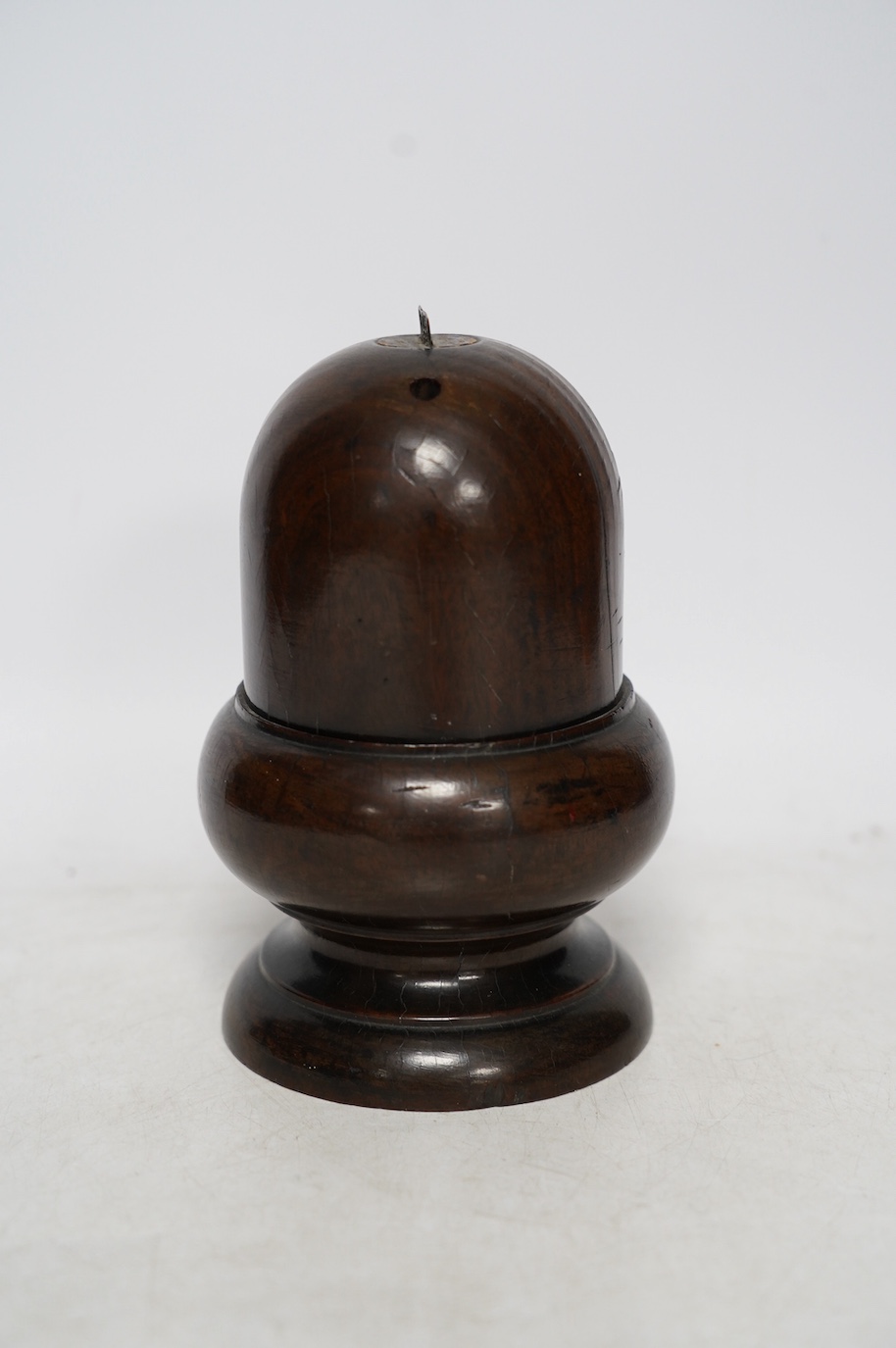 A Lignum Vitae storage vessel with a cutter / blade surmounted on the cover, possibly for cutting and storing spices, 18cm high. Condition - fair to good